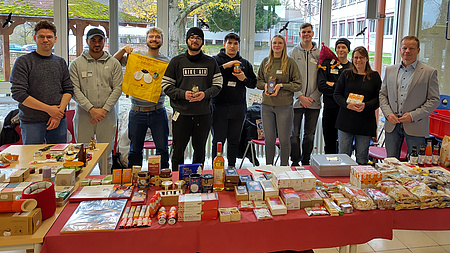 Eine Gruppe von Leuten hinter einem Tisch mit Fairtrade-Produkten.