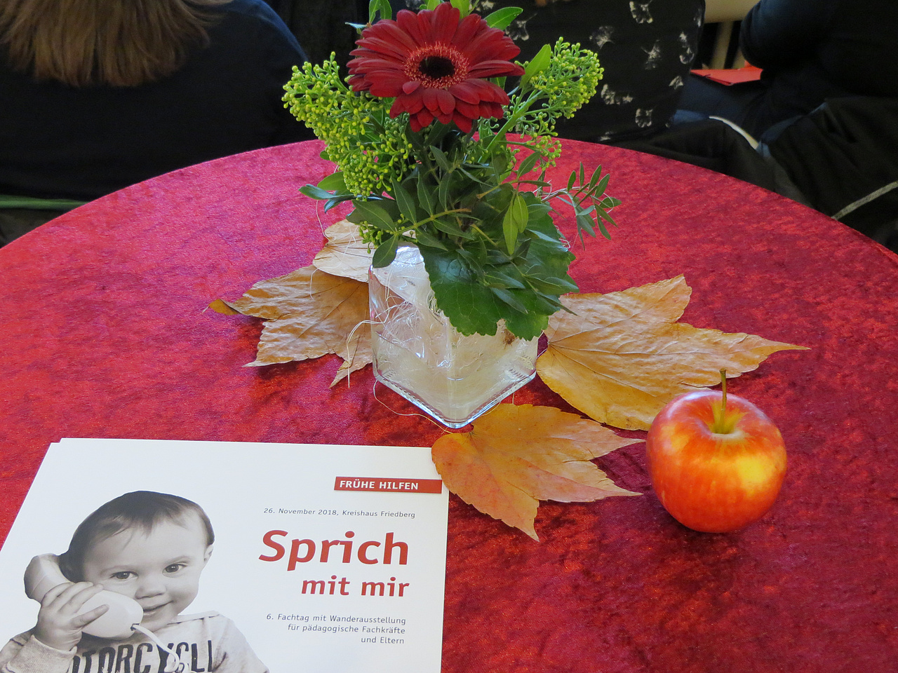 Stehtisch mit Dekoration und Plakat