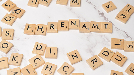 Es ist ein Symbolfoto. Aus Blättchen mit Buchstaben wie beim Spiel Scrabble ist das Wort Ehrenamt gelegt.
