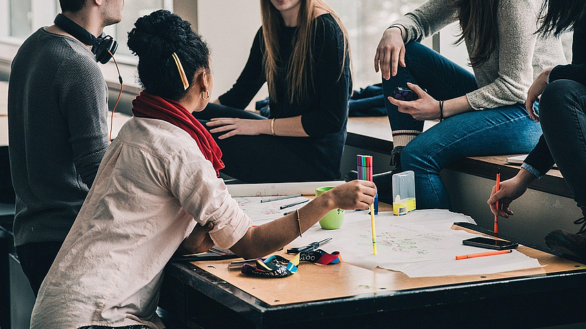 Junge Menschen arbeiten an einer Gruppenarbeit im Büro
