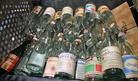Leere Mineralwasserflaschen mit verschiedenen historischen Etiketten