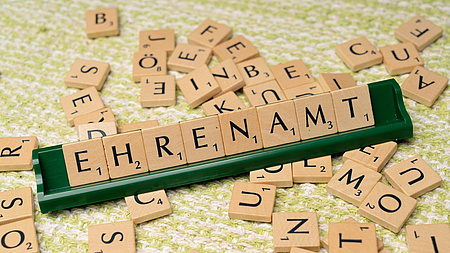Aus Scrabble-Buchstaben wurde das Wort Ehrenamt gelegt.