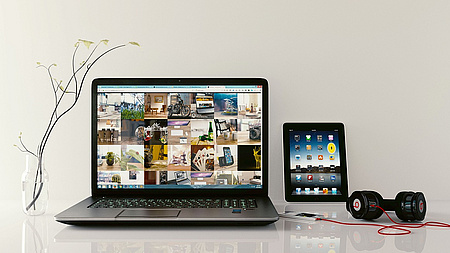 Ein Laptop und ein Tablet auf einem Tisch.