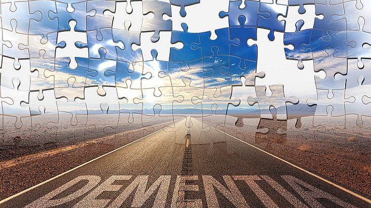 Im oberen Teil fehlende Teile in einem Puzzle, im unteren Teil eine Straße mit der Aufschrift Dementia, Bildquelle: Pixabay geralt