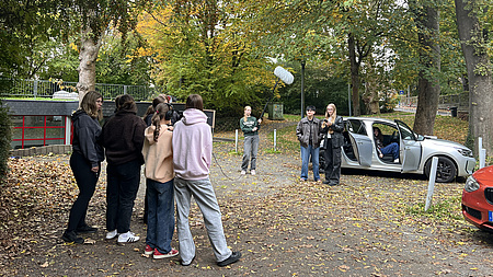 Jugendliche, die mit Kamera-Equipment einen Film drehen.