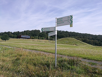 Schilder für Radfahrer auf einem Feldweg.